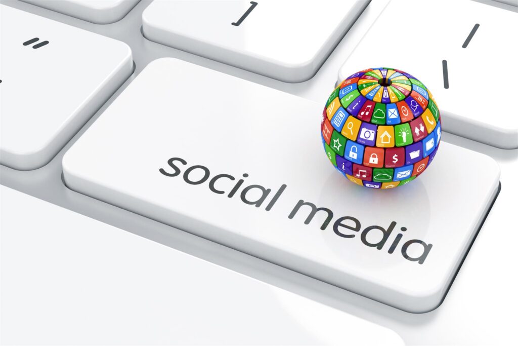 keyboard with social media and a globe representing social media engagement