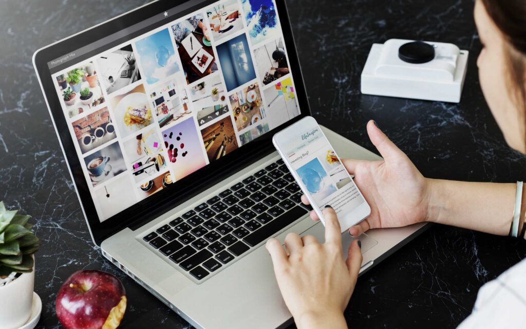 Laptop and smartphone displaying digital marketing strategies to show up in AI Overviews