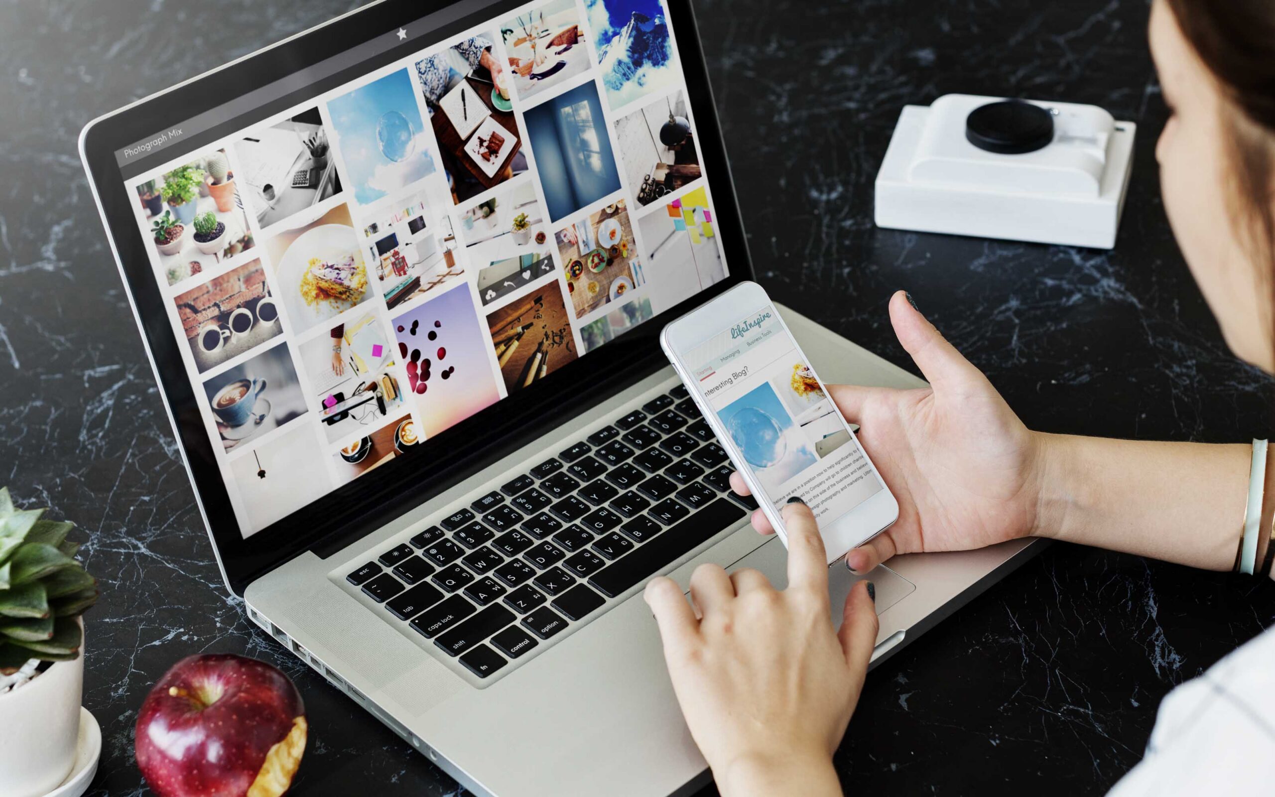 Laptop and smartphone displaying digital marketing strategies to show up in AI Overviews